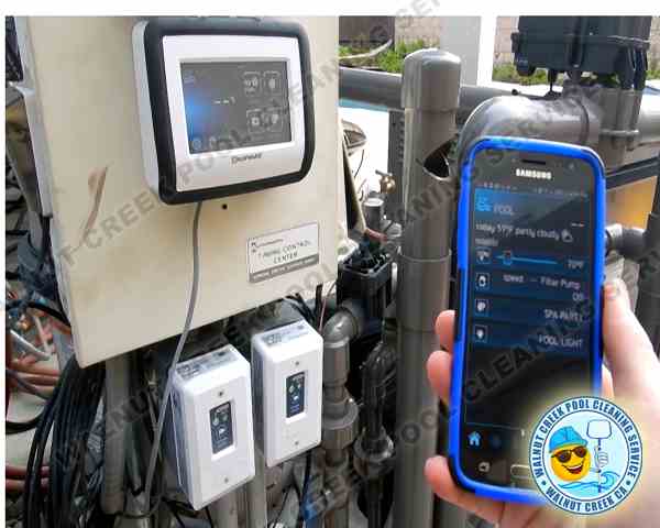 The owner, John, is diagnosing and checking an automated pool system using a phone app in Walnut Creek, CA.
