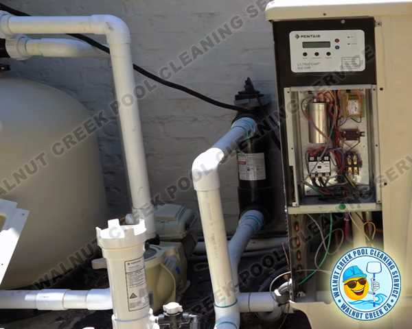 Technician expertly installing a new, energy-efficient heat pump for a swimming pool in Walnut Creek, California.